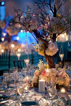 an elegant table setting with flowers and candles