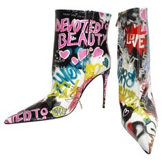 Introducing the Dolce & Gabbana Graffiti Print Ankle Boots – a bold and vibrant expression of fashion that brings together high style and playful artistry. These multicolor patent leather ankle boots are not just shoes; they're a canvas of whimsical graffiti motifs and phrases that make a bold statement with every step. The patent leather construction adds a sleek and polished touch to these ankle boots, while the vibrant multicolor palette ensures they stand out as a playful and eye-catching ac Graffiti Boots, Graffiti Clothes, Colourful Closet, Farfetch Shoes, Chloe 2024, Multicolor Palette, Ankle Boots Heels, Boot Design, Versace Handbags