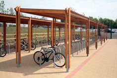 there are many bicycles parked in the bike racks on this street side stand up area