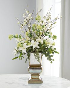 a vase filled with white flowers on top of a table