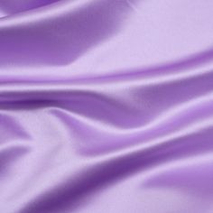 a close up view of a purple silk fabric with very soft folds and smooth lines