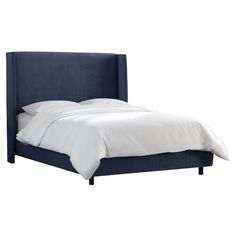 a bed with a blue headboard and white sheets on top of it, against a white background