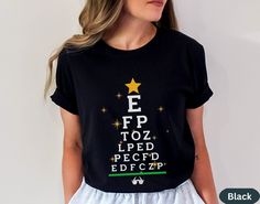 a woman wearing a black t - shirt with the words e fp to zped pe