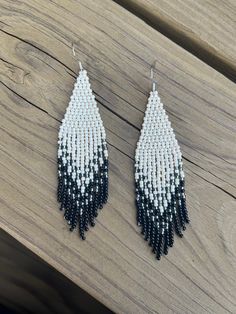 black and white beaded earrings on wooden table