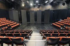 an empty auditorium with rows of chairs