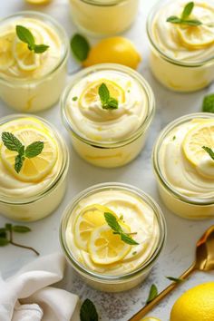 lemon custard in small glass jars with fresh mint garnish on top