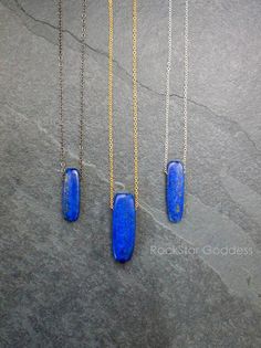 Lapis Lazuli stone, polished and on a custom length chain in you choice of: Gold Filled, Sterling Silver or Gunmetal finish. Select from four different pendant sizes. Lapis Lazuli is a powerful crystal for activating the higher mind and enhancing intellectual ability. It stimulates the desire for knowledge, truth and understanding, and aids the process of learning. It is excellent for enhancing memory. Lapis Lazuli is a stone of communication that can bring truthfulness, openness, and mental cla Blue Pendant Necklace With Cable Chain, Blue Long Drop Necklace As A Gift, Blue Long Drop Necklace As Gift, Blue Long Drop Necklace For Gift, Minimalist Blue Necklace With Rectangular Pendant, Handmade Blue Necklaces With Long Drop Shape, Handmade Blue Necklace With Long Drop, Handmade Blue Long Drop Necklace, Blue Cable Chain Necklace For Gifts