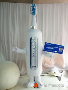 an electric toothbrush on display in front of a white backdrop with a blue tag