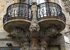 an ornate balcony and balconies on the side of a building with wrought iron railings