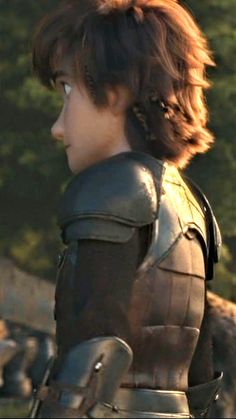 a woman dressed in armor looking off into the distance