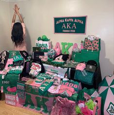 a woman standing in front of a table filled with bags and other items that are on display