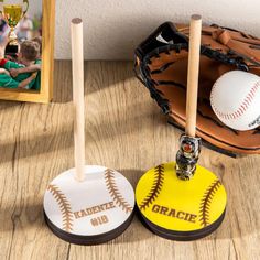 two personalized baseballs and bat on a table