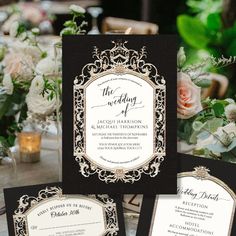 an elegant black and white wedding suite with gold trimmings is displayed on a table