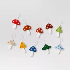 six different colored mushrooms are hanging from strings