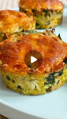 two quiche pies on a plate, one with cheese and spinach in it