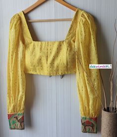 This Made to Order/Made to Measurement/Custom Made Indian Ethnic Blouse. - Fabric - Mul Cotton with Gold Mukaish Dots - Color - Yellow - Padded - Princess Cut - U Neck - Puffed Full Length Sleeves with Multicolor Border - Back Hook Closure - Border at the back Fabric Care : Dry Clean Only Disclaimer: The actual color of the product might slightly differ from the image due to photographic lighting or monitor's display Shipping: This is made to order product. Once you place the order we will provi Cheap Yellow Festive Blouse, Full Length Blouse Designs, Puff Full Sleeve Blouse Indian, Full Puff Sleeves Blouse, Fugi Sleeve Blouse, Traditional Fitted Blouse With Puff Sleeves, Traditional Long Sleeve Padded Choli, Traditional Fitted Blouse Piece With Yoke, Cotton Fitted Lehenga With Self Design