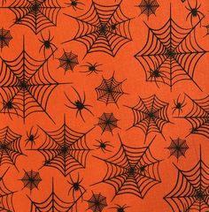 an orange background with black spider webs