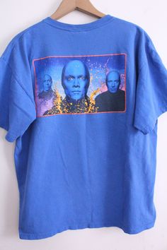 "Blue t-shirt with the bizarre and rad touring act: The Blue Man Group! The front just says 'Blue Man Group' on the chest and the back has a typical image of them. Heck yeah! Good condition. 'Blue Man Group' brand 100% Cotton Size L Measurements: 26\" long 23\" wide 7\" sleeve length T-2" Blue Band Merch T-shirt, Blue Graphic Print T-shirt For Fan Conventions, Blue Crew Neck Tops For Fan Conventions, Casual Blue T-shirt For Fan Conventions, Bridesmaid Games, Blue Man Group, Rude People, Heck Yeah, Silky Blouse