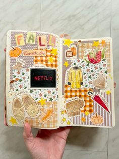 a hand holding an open book with stickers on it and the word netflix written in red