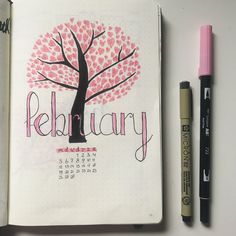 a calendar with a tree on it next to two markers and a marker pen that says, relauary