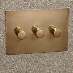 three knobs are on the side of a light switch