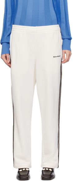 French terry lounge pants. · Concealed drawstring at elasticized waistband · Three-pocket styling · Logo embroidered at front and back · Striped trim at outseams Part of the Wales Bonner x adidas Originals collaboration. Supplier color: Chalk white Relaxed Fit Pants With Three Stripes For Loungewear, Athleisure Cotton Sweatpants With Three Stripes, Cotton Athleisure Sweatpants With Three Stripes, White Streetwear Bottoms With Logo Detail, White Logo Bottoms For Streetwear, White Bottoms With Logo Detail For Streetwear, Cotton Joggers With Three Stripes In Relaxed Fit, Sporty Sweatpants With Three Stripes For Loungewear, Sporty Three Stripes Sweatpants For Loungewear