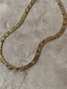 Materials: • Vintage 24k gold-plated brass chain Measurements: • 24” Notes: • Our beloved, best-selling bracelet now has a matching necklace! circa 1980s/90s. Backside of chain is plain with nugget styled etching, so the I love you part can face inward, like a secret message! Engraved Gold Plated Chain Necklace, Gold Plated Engraved Chain Necklace, Engraved Gold-plated Chain Necklace, Gold Nameplate Chain Necklace For Anniversary, Gold Metal Chain Necklace For Anniversary, Gold Nameplate Necklace With Chain, Gold Nameplate Chain Jewelry, Everyday Engraved Gold Chain Necklace, Gold-plated Engraved Chain Necklace