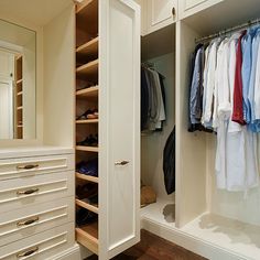 an organized closet with white cabinets and drawers