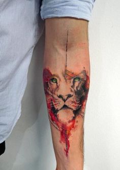 a man with a tattoo on his arm has a watercolor cat design on it