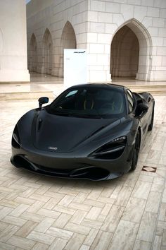 a black sports car parked in front of a building