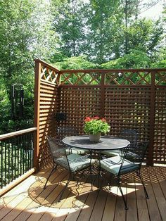 a table and chairs on a wooden deck