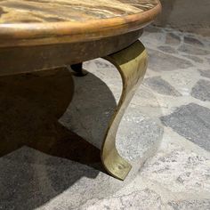 a wooden table sitting on top of a stone floor