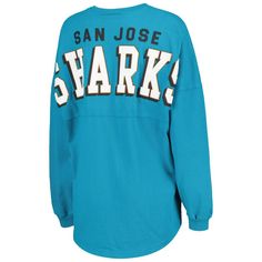 Boost your collection of official San Jose Sharks gear with this Spirit jersey T-shirt from Fanatics Branded. It features a lace-up V-neckline and dropped shoulders, ensuring that you'll be the most stylish fan on game day. The low-puff graphics on this cotton tee make it clear that your loyalty to the San Jose Sharks is second to none.Boost your collection of official San Jose Sharks gear with this Spirit jersey T-shirt from Fanatics Branded. It features a lace-up V-neckline and dropped shoulde Collegiate V-neck Top With Letter Print, Team Spirit Long Sleeve Fan Merchandise Tops, Blue Casual Tops For Game Day, Crew Neck Tops With Team Name For Fans, College Long Sleeve Tops With Team Logo, Fan Apparel Long Sleeve Tops With Team Logo, Long Sleeve Tops With Team Logo For Fans, Long Sleeve Tops With Team Logo, Collegiate Style Cotton V-neck Top