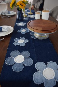 a blue table runner with flowers on it