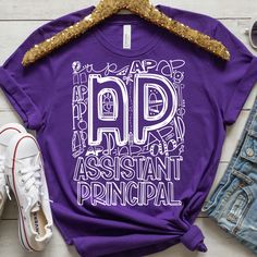 a purple shirt with the words app assistant principals printed on it next to some shoes