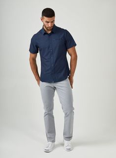 We created the perfect short sleeve button up, with the right mixture of comfort and style, just for you. Our performance shirts have 4-way stretch, are moisture wicking, wrinkle resistant and above all a great new addition to your wardrobe. The performance shirt will be your go-to for any occasion - day to night. This is a shirt that will have you satisfied at any given time. Details Model is 6'1" and wears a size medium. Care: Machine wash cold on delicate cycle with similar colors. Do not use Navy Slim Fit Shirt For Summer, Navy Cotton Tops For Semi-formal Occasions, Navy Cotton Top For Semi-formal Occasions, Navy Casual Shirt For Business Casual, Navy Business Casual Shirt, Relaxed Fit Short Sleeve Semi-formal Top, Semi-formal Cotton Short Sleeve Shirt, Relaxed Fit Short Sleeve Top For Semi-formal Occasions, Navy Casual Tops For Business Casual