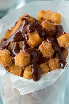 the chocolate sauce is drizzled on top of the fried food in the container