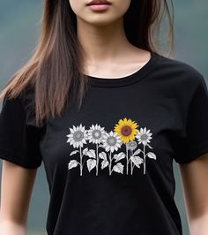 Elevate your style with our Minimalistic Sunflowers Unisex Tee, available in multiple colors and sizes. This charming tee features a minimalistic design of one-color sunflowers, offering a versatile and timeless look. #12 Boho Classic unisex jersey short sleeve tee fits like a well-loved favorite. Soft cotton and quality print make users fall in love with it over and over again. Ribbed knit collars to bolster shaping. Shoulders are tapered for a better fit over time. Dual side seams hold the garment's shape for longer. Fabric Details Made with 100% Airlume combed and ring-spun cotton, a lightweight fabric (4.2 oz/yd² (142 g/m²)) that is easy to layer, breathable. Perfect for active and leisure wear. Style Features The retail fit is perfect for casual and semi-formal settings. The crew neck Black T-shirt With Sunflower Print For Spring, Spring Black T-shirt With Sunflower Print, Single Sunflower, Quiet Beauty, Sunflower Shirt, Monochrome Fashion, Minimalistic Design, Prism Color, Boho Vibe