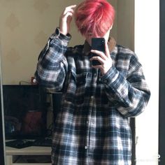 a person with red hair taking a selfie