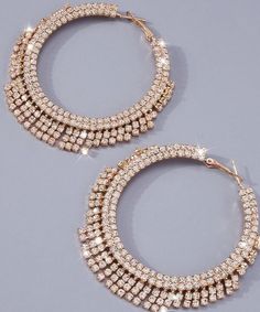 These women exaggerated rhinestone tassel big hoop earrings are a show stopper! Perfect for date night or the holidays. Pair it with your favorite dress, leather look or tank for a star studded look. Description: Color: Gold Gender: Women Material: Glass Earring Studs Materials: Stainless Steel Measurements in inches: Size Eardrop Height Eardrop Width one-size 2.9 3 Luxury Metal Hoop Earrings For Party, Trendy Sparkling Hoop Earrings For Party, Chic Dangle Hoop Earrings For Evening, Luxury Dangle Hoop Earrings For Party, Glamorous Party Hoop Earrings With Rhinestones, Glamorous Rhinestone Hoop Earrings For Party, Chic Bling Jewelry For Night Out, Sparkling Jewelry For Night Out, Trendy Fringe Jewelry For Parties