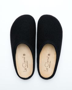 Description: The Nebraska Clog in black is an Italian take on a European classic. The Nebraska is one of the most versatile clog style slippers available. From home to the office to weekend, the minimalist design of these clogs will take you anywhere in comfort. The anatomical self-molding latex and thermoforming cork insole provide a firm customized comfort, and the insole is completely removable for cleaning. LeClare Slippers are exclusively handcrafted in our small-batch factory in Treviso, I Wool Clogs, Clog Style, Clogs Style, Natural Contour, Wool Slippers, The Minimalist, Outdoor Wear, Black 7, Slide Slipper