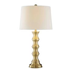 a gold table lamp with a white shade