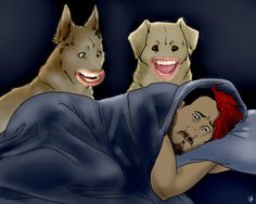 two dogs and a man laying in bed