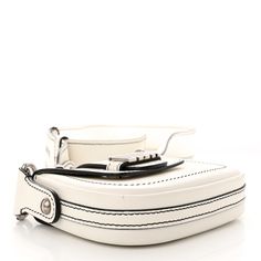 a white suitcase with black handles and straps on it's side, sitting against a white background