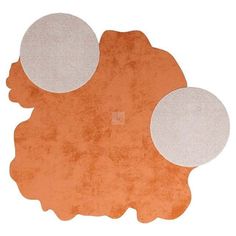 an orange and white rug with three circles on it, in front of a white background