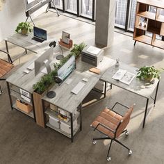 an overhead view of a desk with two chairs and a computer on it, in the middle of a large room