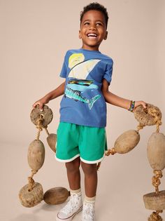 Sun, sea, dhow (Kenyan sailboat), and shark converge on this dazzling summertime graphic. Featuring Tea's trademark super-soft, comfy feel. This short sleeve tee is crafted of 100% cotton jersey that retains the color and shape, wash after wash. Pair with Everyday Pants, joggers, and shorts for a completed look. Details: Standard fit Crew neckline Interior neck tape for lasting quality Short sleeve Above thigh length 100% cotton jersey Machine wash Imported Dress Romper Outfit, Everyday Pants, Romper Outfit, Kids Boutique, Outerwear Outfit, Tea Collection, Wax Print, Newborn Boy, New Arrival Dress