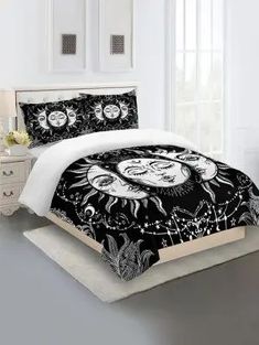 a black and white bed with sun and moon designs