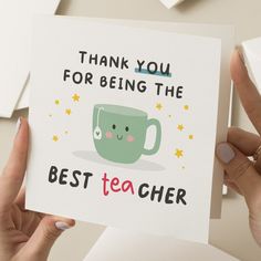 a person holding up a card that says thank you for being the best teacher