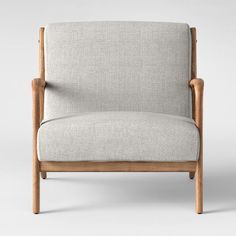 an upholstered chair with wooden arms and legs